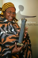 Chair of the Phomolong Support Group, Mathuso Moroeng, with the International Service human rights award. Copyright Andy Aitchison.